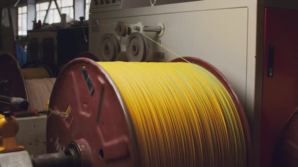 Spinning Reel with Yellow Cable in Cable Production Closeup