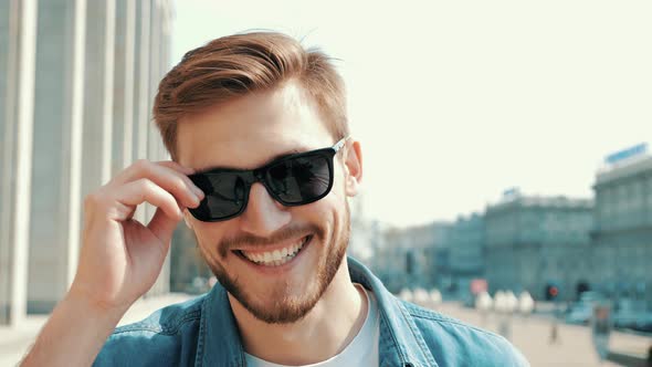 Handsome smiling man in casual clothes outdoors alt