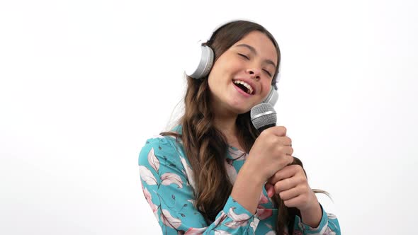 Vocal Training of Happy Kid Singer in Studio Headphones Singing in Microphone Music alt