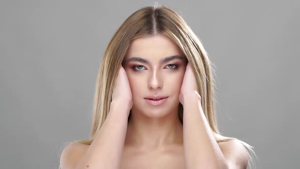 Girl Stroking Healthy Long Hair and Smiling alt