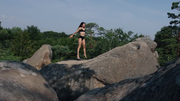 Pretty Woman is Kneeling on Mat Lifting Body of Waist alt