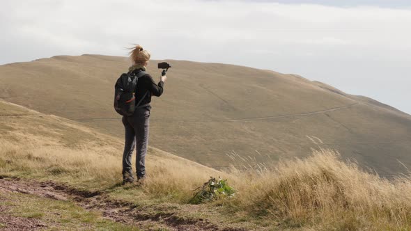 Female hiker  on Midzor peak close-up 4K 2160p 30fps UltraHD footage - Woman films nature and hikes  alt