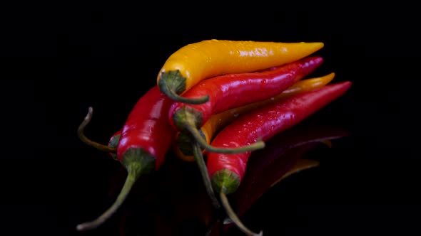 Hot chilli peppers isolated rotating on a black background.