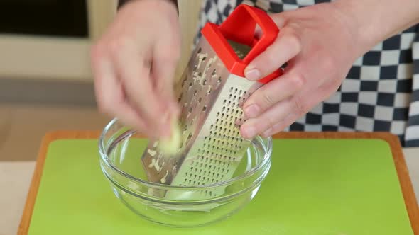 Grating Peeled Apples in a Glass Bowl alt