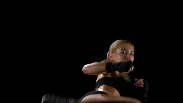 Woman Boxer Training Herself in a Dark Studio. Slow Motion alt