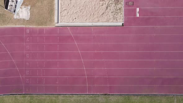 Drone Flying Along Running Track Shot From Directly Above