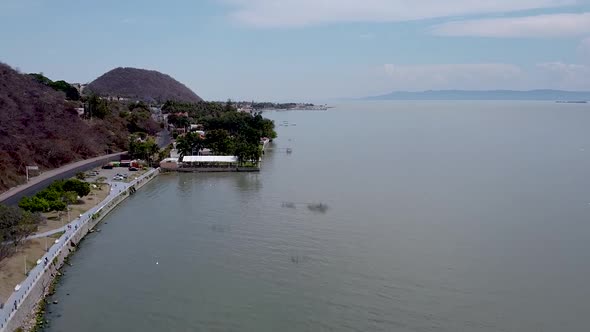 Rising aerial drone footage above Lake Chapala and Chapala town in Jalisco, Mexico alt