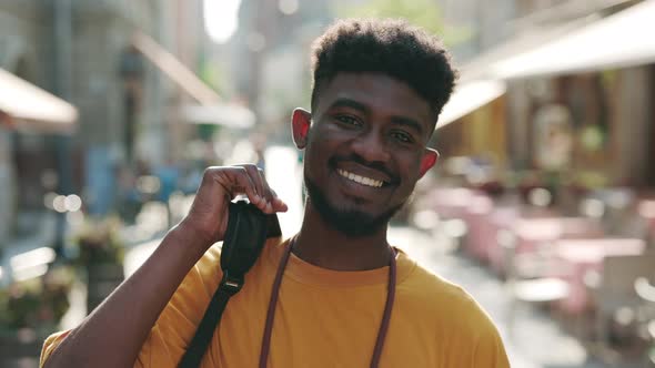 Portrait of Black Man Smiling Sincerely on City Street alt