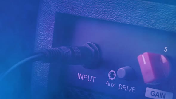 Cable Plugged In And Out Of Speaker In Smoke And Lights alt