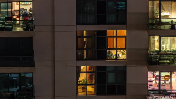 Windows of Apartment Building at Night Timelapse the Light From Illuminated Rooms of Houses alt