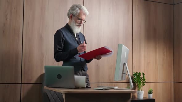 Grayhaired Adult Architect Checks Drawings of Objects Thoughtful University Lecturer Checks alt