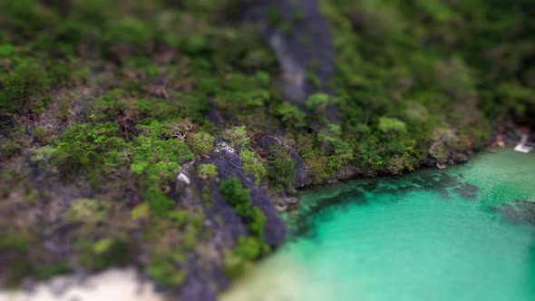 Woman Sitting On Limestone Rocks Above Coastline alt