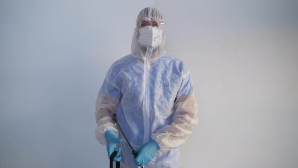 When Disinfection is Finished He Can Take Off Protective Outfit to Breathe Free alt