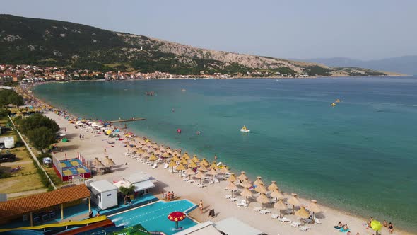 ourists supping at the coast of Krk Island, Croatia - Aerial Drone View of Adriatic Sea, Boats, Beac alt