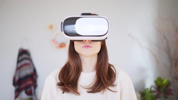 A Young Woman in a White Virtual Reality Headset