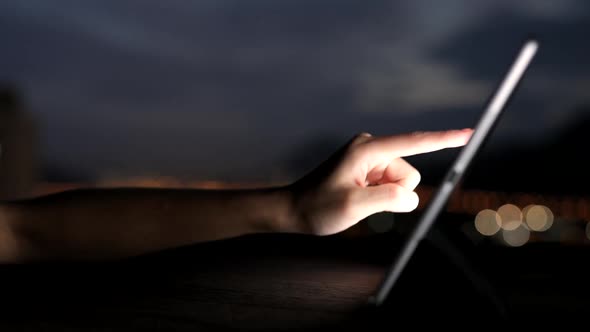 Using tablet computer at night  alt