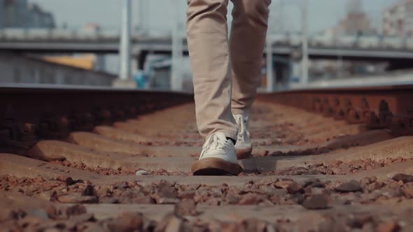 Man Walks To Home On Railroad Tracks After Canceled Public Transport.Tourist Legs Walking On Railway alt