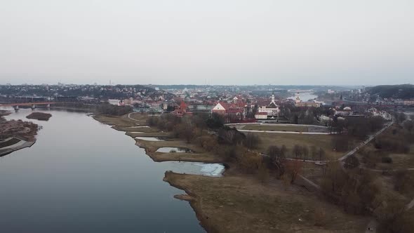 Ascend reveal aerial view of Kaunas city oldtown rooftops alt