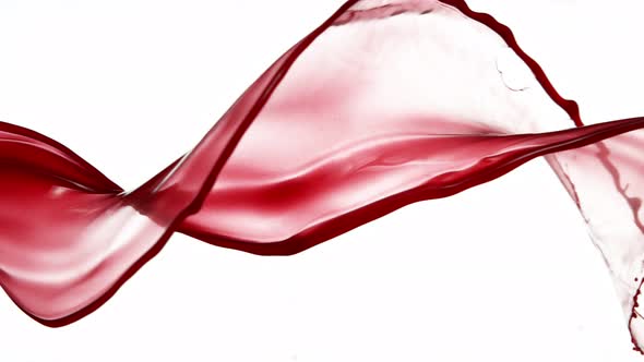 Super Slow Motion Shot of Red Wine Spiral Splash Isolated on White Background at 1000Fps alt