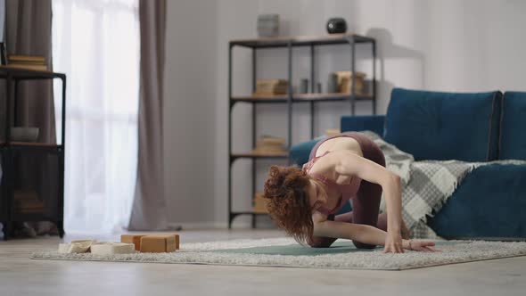 Woman is Doing Physical Exercises at Home Practicing Yoga Asanas Training for Spinal Prevention of alt