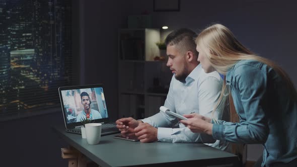 Extended Videoconferencing Between Two Directors on Computer Late at Night alt
