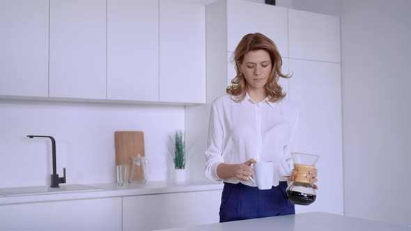 Female Pours Coffee in Flat alt