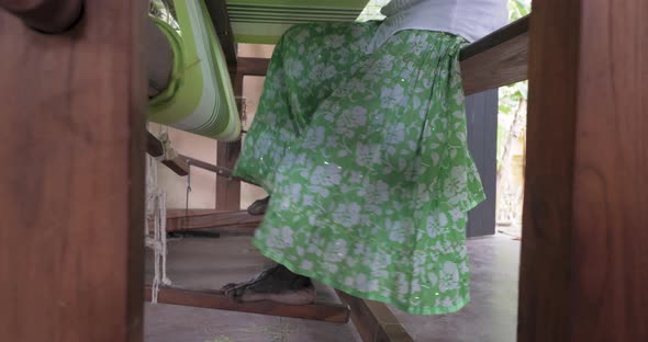 A Footage of a Woman Using Loom in a Traditional Asaian Factory