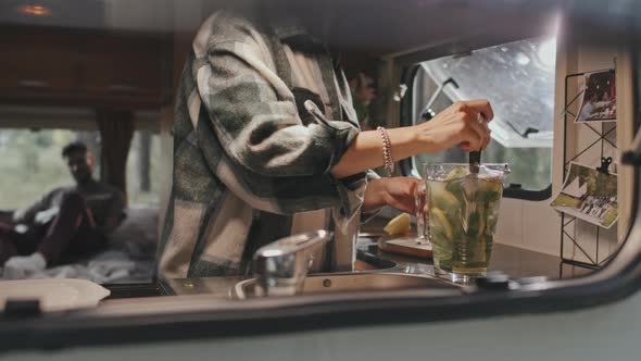 Woman Making Lemon and Mint Water in Camper alt