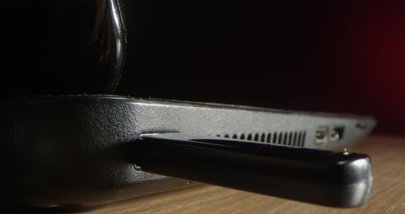 Inserting A Usb Stick Inside A Computer To Hack It On A Black And Red Background alt