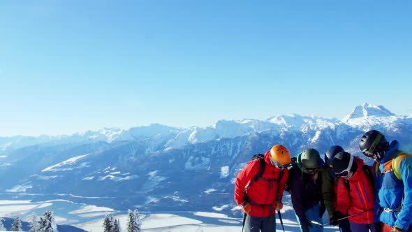 Skiers with ski interacting on snowy landscape alt