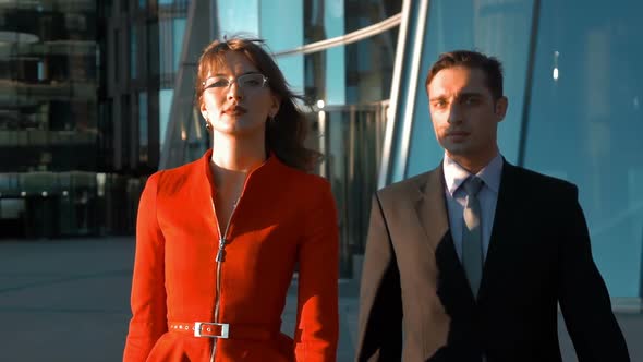 Two Serious Business People Walking alt