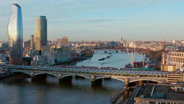 Aerial dolly forward looking west over Blackfriars bridge towards London eye and House of parliament alt