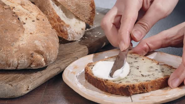 Person Spreading Toast with Butter alt