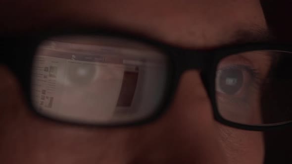 Website Reflecting in Glasses of Caucasian Male alt