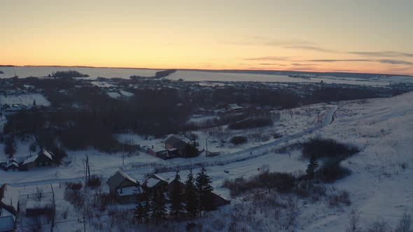 Russian Village in Winter Under a Bright Cloudy Sky