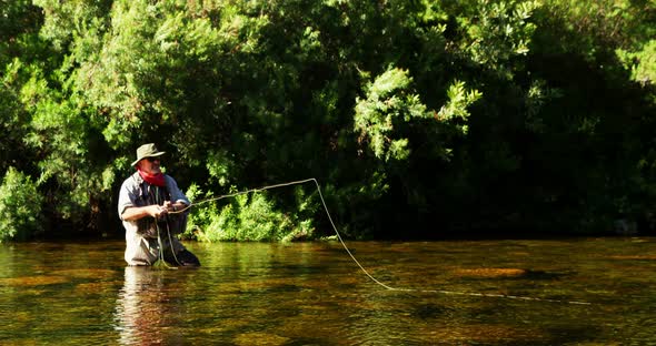 Man fly fishing in river alt