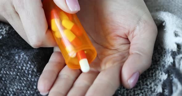 Person Pours Medical Pills Into Hand