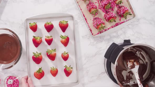 Flat lay. Step by step. Dipping organic strawberries into melted milk chocolate. alt