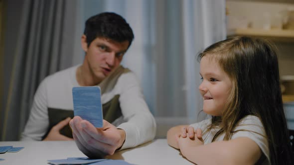 Father and Daughter in the Evening in the Kitchen Play Board Card Games