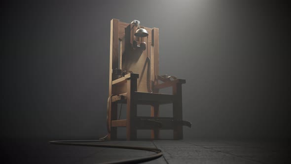 Wooden electric chair in the foggy room spotlight. Camera slow track in. 4K HD