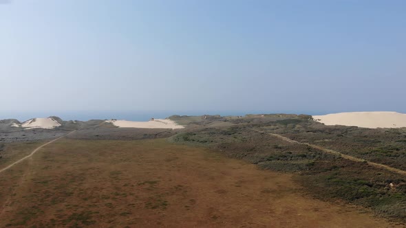Aerial view of dunes by the North Sea shoreline at Rubjerg Knude, Løkken, Denmark alt