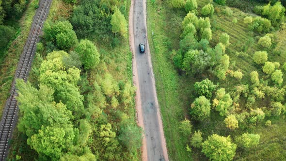 Flying Over Car Driving on Road Among Green Forest, Travelling By Car Concept