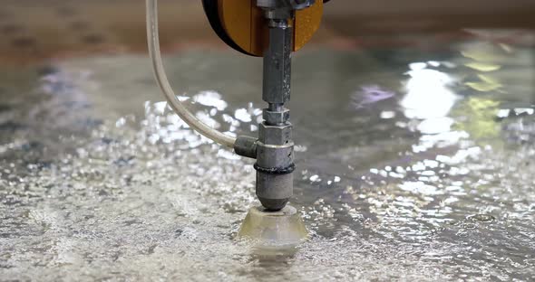 Automated machine for cutting metal with water jet. Water under pressure cuts objects