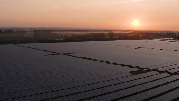 Aerial view over solar farm at sunrise