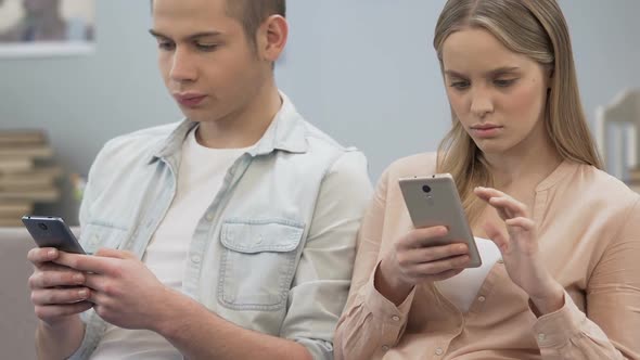 Girl and Boy Spending Time Online on Smartphones, Silence Problem, Bad Habit alt