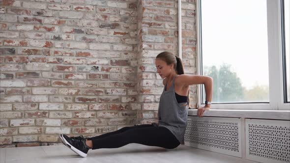 Young Woman Doing Sports Exercises to Strengthen the Muscles of the Hands alt