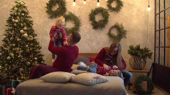 Cheerful Family Having Fun Together on Bed