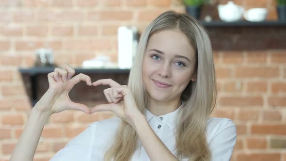 Handmade Heart Sign by Young Woman, Indoor alt