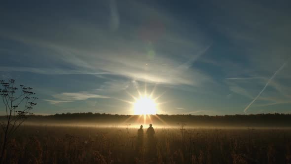 Couple on the background of the sun alt