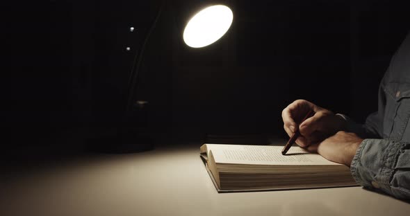 Man Reading Book at His Desk